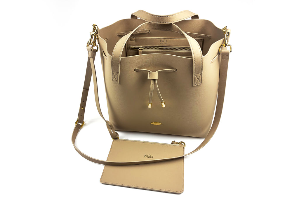 Beige handbag with matching inner-pouch on a white background