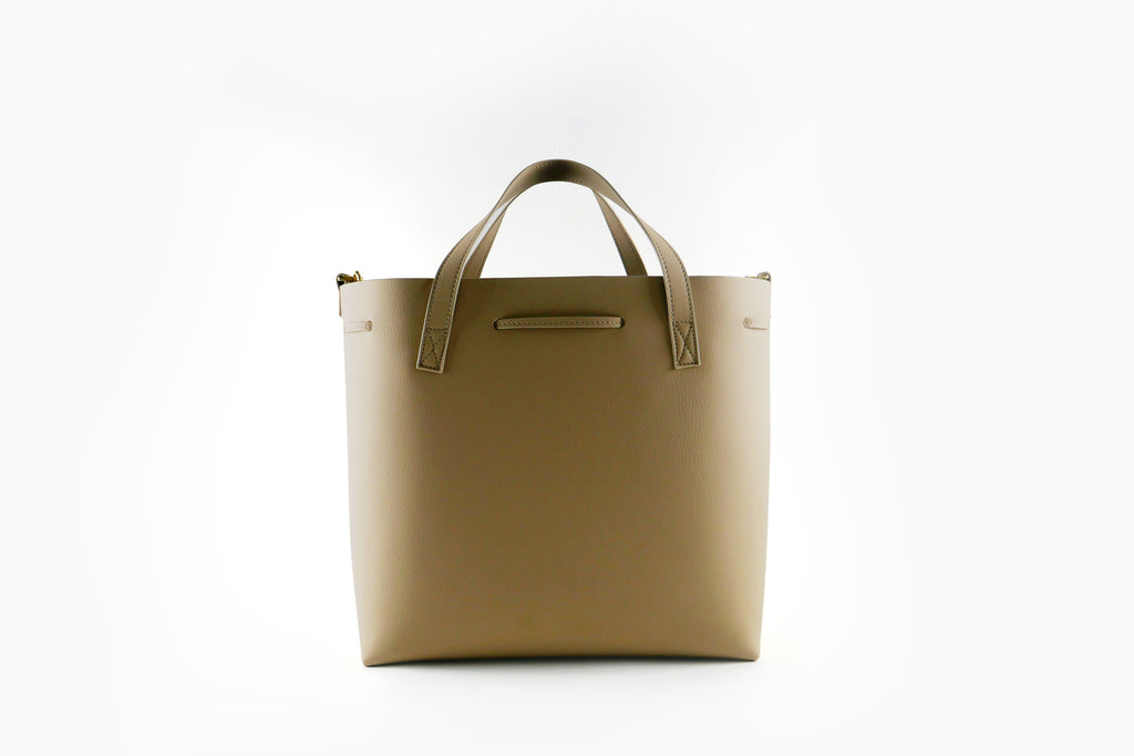 Backside of beige tote bag on a white background